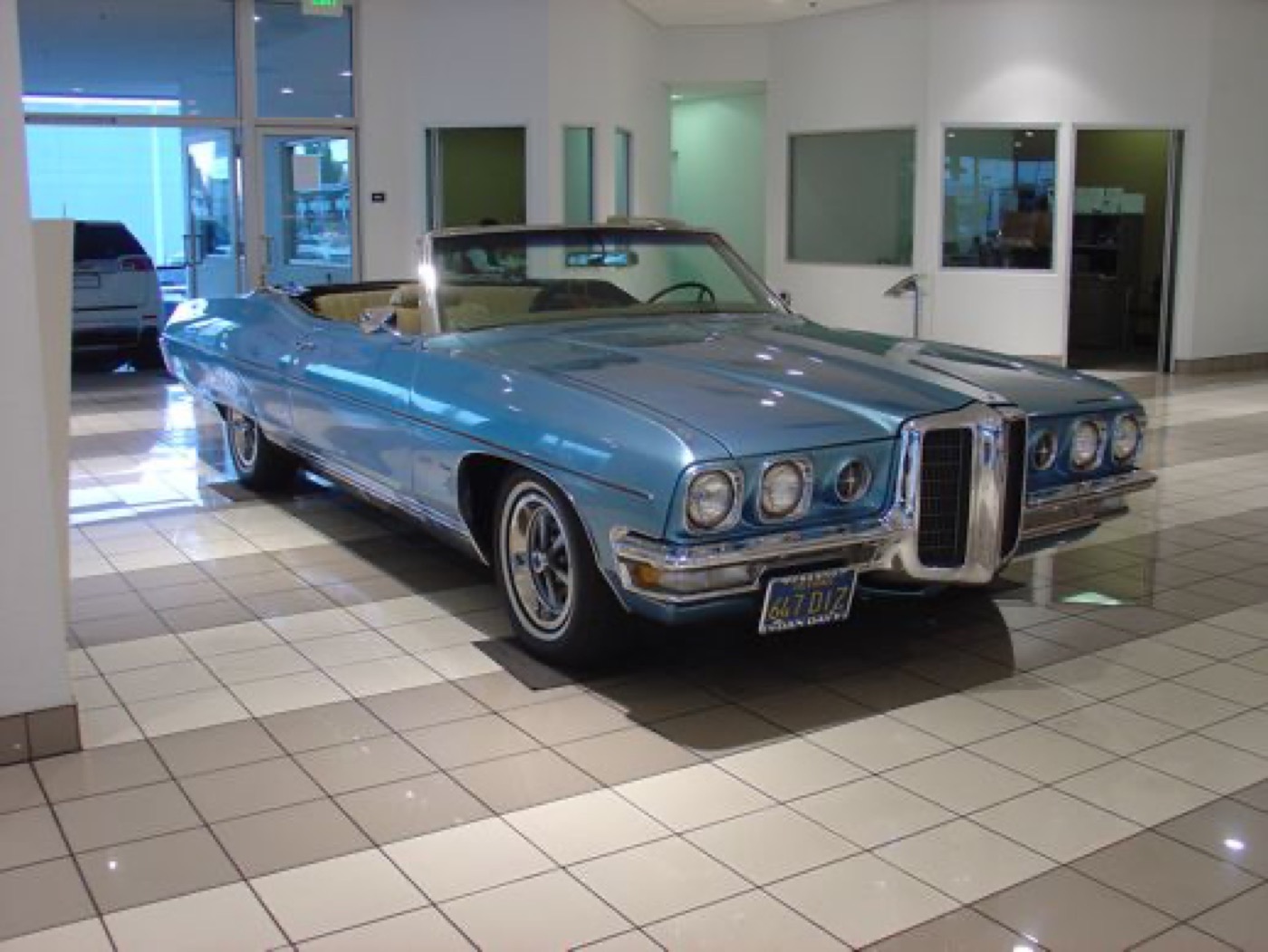 Light blue Pontiac convertible, chrome grille shining