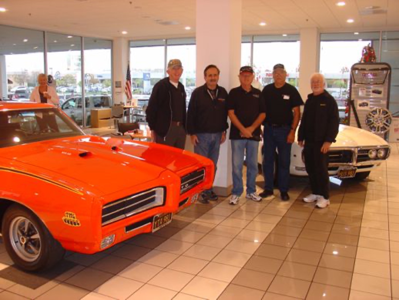Proud club members beside the orange Judge