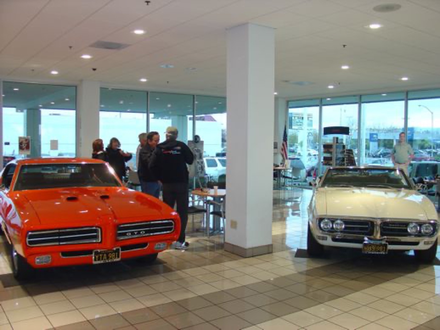 Orange Judge and white Firebird, showroom display
