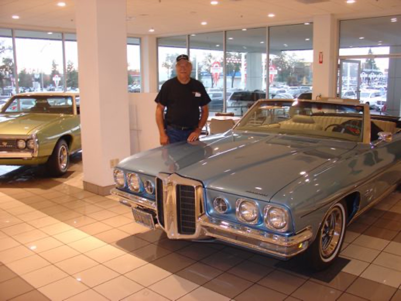 Member showing off blue Pontiac convertible