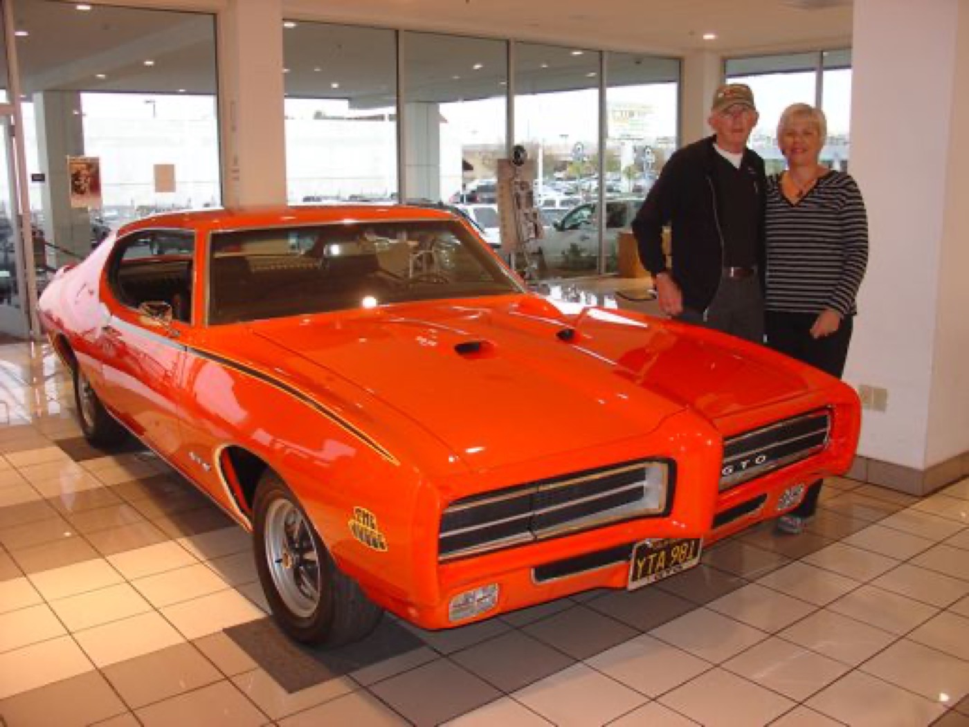 Orange GTO Judge gleaming on the showroom floor