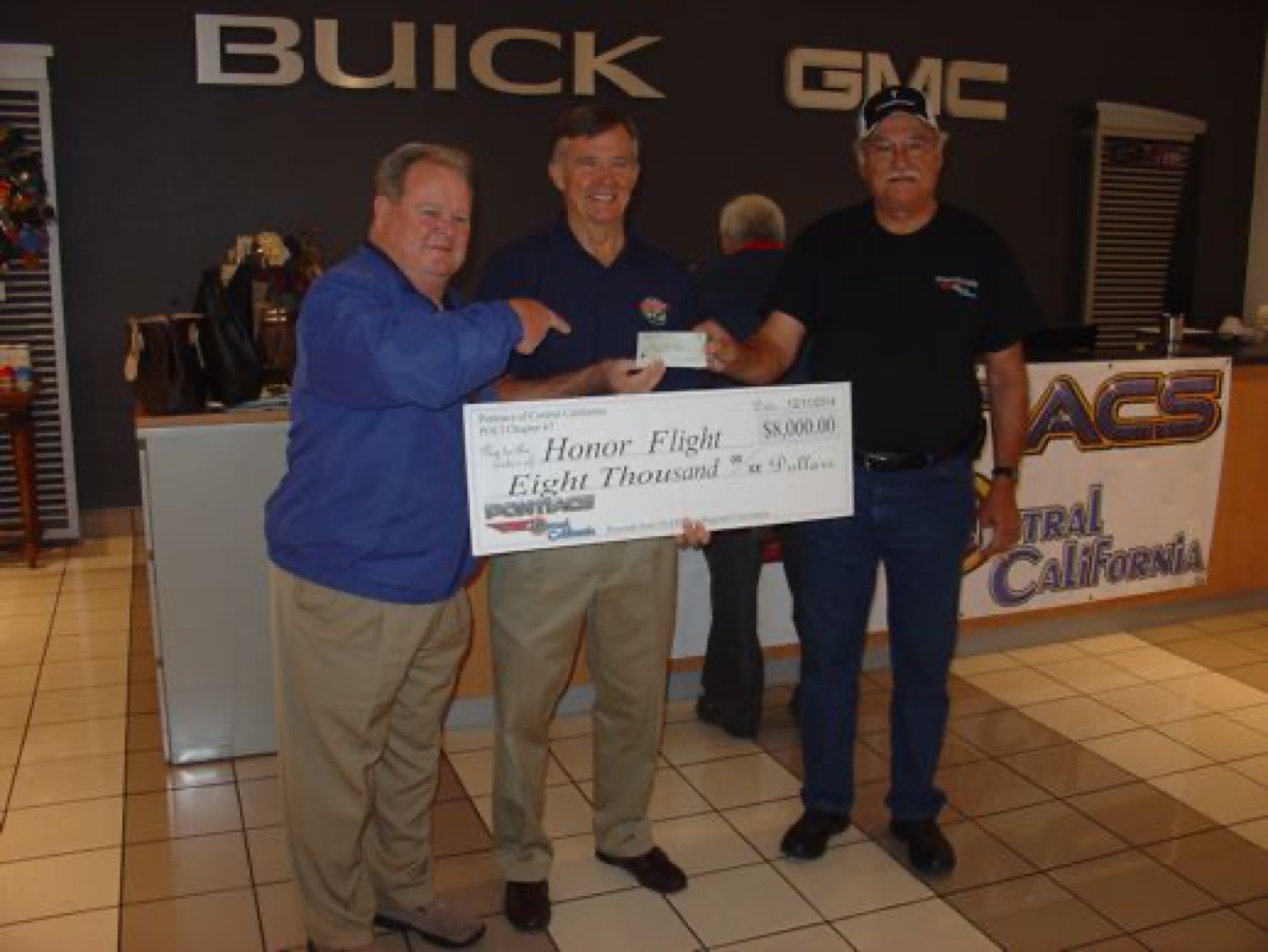 Honor Flight donation handoff with warm handshake