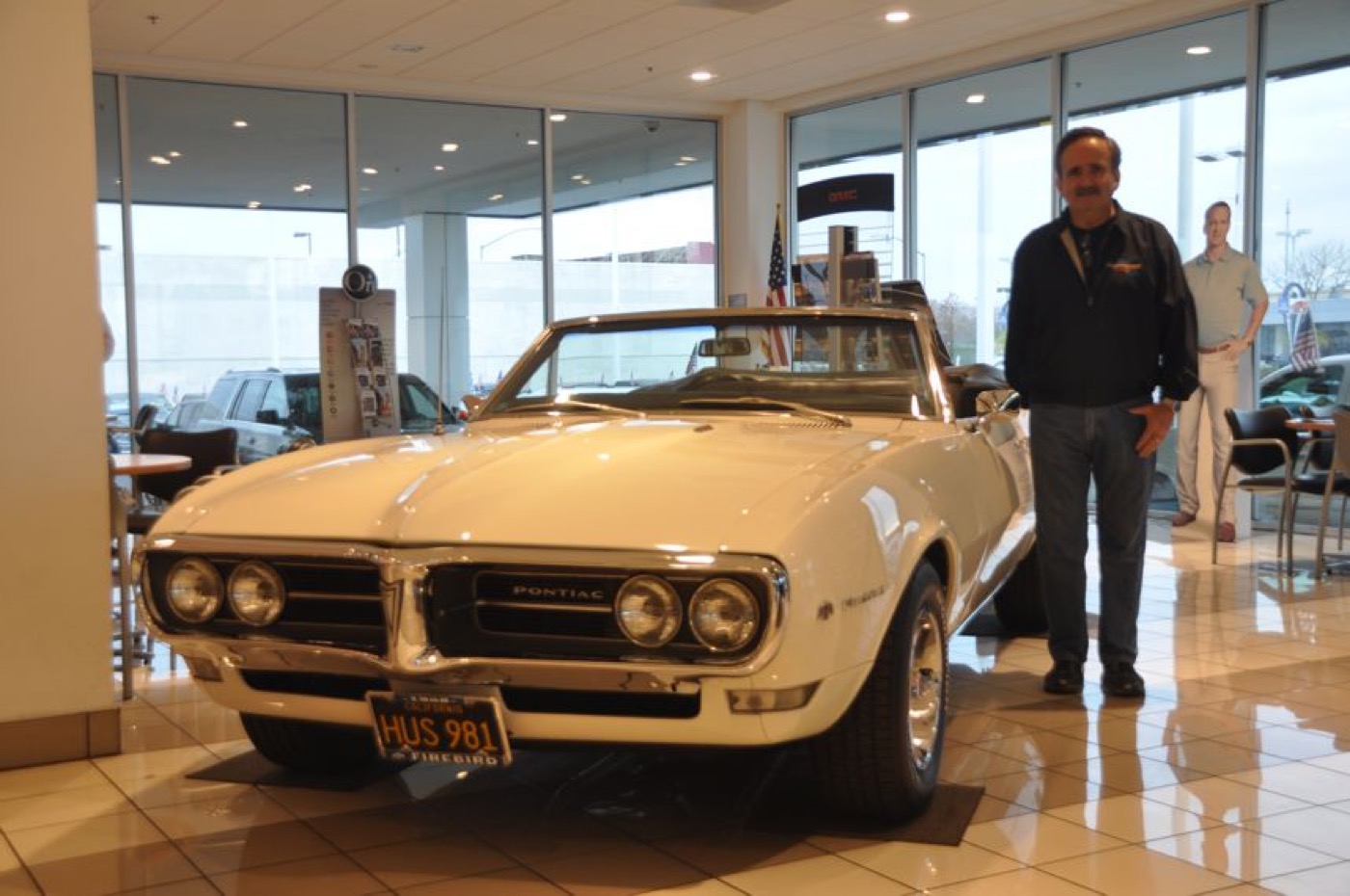 Smiling owner with white Firebird convertible