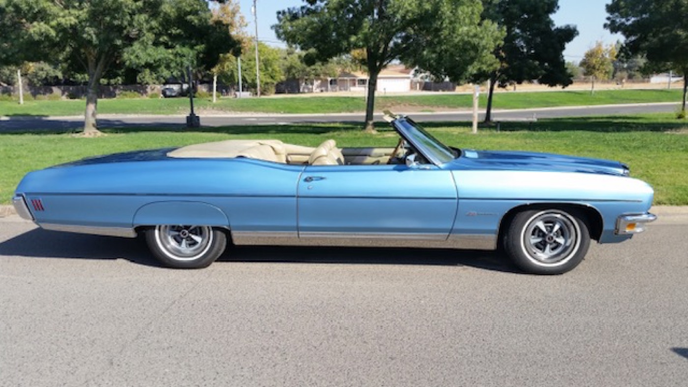 Sky-blue convertible cruiser shining on the grass